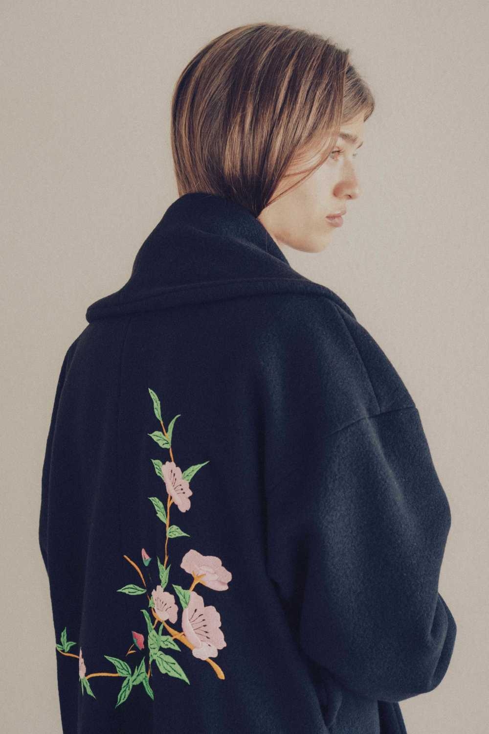 Black coat shop with embroidered flowers